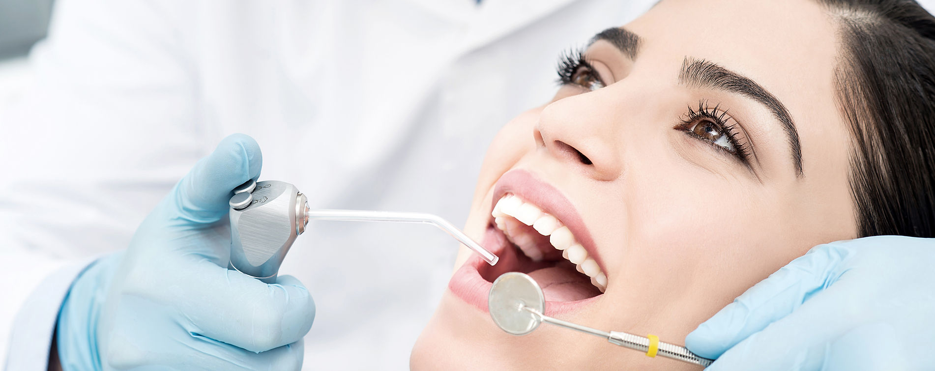 Smiling woman in the dental chair during a dental exam