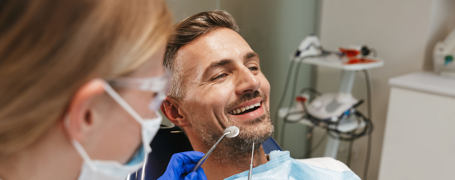 Smiling man in the dental chair with his dentist